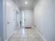 Bright entryway with tile flooring, white walls, and neutral decor at 2150 White Dahlia Dr, Apopka, FL 32712