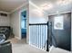 Upstairs hallway with modern black railing, elegant lighting, and doorway views, showcasing a stylish and connected living space at 2150 White Dahlia Dr, Apopka, FL 32712