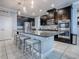 Spacious kitchen with dark cabinets, granite counters, and stainless steel appliances at 2150 White Dahlia Dr, Apopka, FL 32712