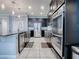 Open concept kitchen with island, stainless steel appliances, and dark cabinetry at 2150 White Dahlia Dr, Apopka, FL 32712