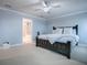 Spacious main bedroom with a ceiling fan and a doorway leading to the bathroom with a soaking tub and glass shower at 2150 White Dahlia Dr, Apopka, FL 32712