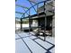This outdoor patio has a built-in grill, bar, table and chairs, and is partially covered with an enclosed screen at 2150 White Dahlia Dr, Apopka, FL 32712