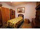 Small bedroom with wood furniture and a twin bed at 3140 Se 23Rd Pl, Sumterville, FL 33585