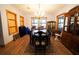 Formal dining room with a large table, chandelier, and hardwood floors at 3140 Se 23Rd Pl, Sumterville, FL 33585