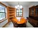 Bright dining room with built-in shelving and wood furniture at 3140 Se 23Rd Pl, Sumterville, FL 33585