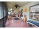 Relaxing screened porch with rocking chairs, tile floor, and access to the backyard at 3140 Se 23Rd Pl, Sumterville, FL 33585