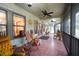 Inviting screened porch with rocking chairs and access to the front entrance at 3140 Se 23Rd Pl, Sumterville, FL 33585
