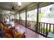 Spacious screened porch overlooking the backyard, perfect for relaxing at 3140 Se 23Rd Pl, Sumterville, FL 33585