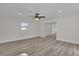 Bright living room featuring hardwood floors, a ceiling fan, and neutral paint at 3425 Balsam Dr, Winter Park, FL 32792