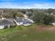 Aerial view of a house with a screened patio and backyard at 4351 Hammersmith Dr, Clermont, FL 34711