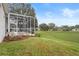 Screened patio, landscaped yard, and neighborhood view at 4351 Hammersmith Dr, Clermont, FL 34711