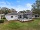 House exterior showcasing a screened patio and yard at 4351 Hammersmith Dr, Clermont, FL 34711