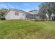 House exterior with a screened patio and landscaping at 4351 Hammersmith Dr, Clermont, FL 34711