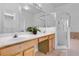 Main bathroom with double vanity, shower, and separate tub at 4351 Hammersmith Dr, Clermont, FL 34711