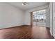 Spacious bedroom featuring wood flooring and sliding glass doors to a sunroom at 4351 Hammersmith Dr, Clermont, FL 34711