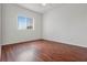 Spacious bedroom with hardwood floors and large window, offering ample natural light at 4351 Hammersmith Dr, Clermont, FL 34711