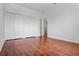 Bright bedroom with hardwood floors and double door closet for extra storage at 4351 Hammersmith Dr, Clermont, FL 34711