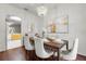 Bright dining room with hardwood floors and a view into the kitchen at 4351 Hammersmith Dr, Clermont, FL 34711