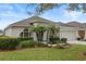 One-story house featuring a well-manicured lawn and palm trees at 4351 Hammersmith Dr, Clermont, FL 34711