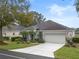Landscaped one-story house with a driveway and a two-car garage at 4351 Hammersmith Dr, Clermont, FL 34711