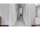 Long hallway with tile floors connecting various rooms at 4351 Hammersmith Dr, Clermont, FL 34711