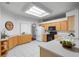 Well-lit kitchen with ample cabinetry and skylight at 4351 Hammersmith Dr, Clermont, FL 34711
