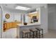 Kitchen features an island with seating and wood cabinets at 4351 Hammersmith Dr, Clermont, FL 34711