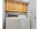 Laundry room with washer, dryer, and upper cabinets at 4351 Hammersmith Dr, Clermont, FL 34711