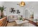 Living room with a couch, coffee table, and modern art at 4351 Hammersmith Dr, Clermont, FL 34711