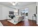 Living room with hardwood floors, sliding glass doors, and a view of the backyard at 4351 Hammersmith Dr, Clermont, FL 34711