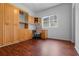 Home office with built-in wooden desk and cabinets, offering great storage at 4351 Hammersmith Dr, Clermont, FL 34711