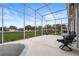 Relaxing screened patio with seating area and view of the backyard at 4351 Hammersmith Dr, Clermont, FL 34711