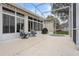Relaxing screened patio with seating area and view of the backyard at 4351 Hammersmith Dr, Clermont, FL 34711