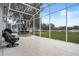 Spacious screened porch overlooking a backyard and neighboring homes at 4351 Hammersmith Dr, Clermont, FL 34711