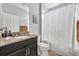 Bathroom featuring granite countertop, neutral wall color, and shower with white curtain at 504 Narrow View Ln, Groveland, FL 34736