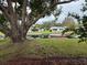 Waterfront property with lush lawn and mature tree at 530 Mar Nan Mar Place, Clermont, FL 34711