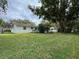 Spacious backyard with a large tree and grassy area at 530 Mar Nan Mar Place, Clermont, FL 34711