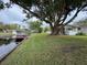 Waterfront backyard with large tree and boat dock at 530 Mar Nan Mar Place, Clermont, FL 34711