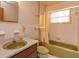 Bathroom with vintage green bathtub, shower, and tiled walls at 530 Mar Nan Mar Place, Clermont, FL 34711