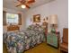 Bedroom with floral bedding, dresser, and ceiling fan at 530 Mar Nan Mar Place, Clermont, FL 34711