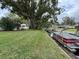 Waterfront lot with boat and lush green grass at 530 Mar Nan Mar Place, Clermont, FL 34711