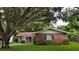 Brick house with a large tree in the front yard at 530 Mar Nan Mar Place, Clermont, FL 34711