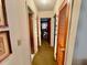 A hallway with wood doors and carpeted flooring at 530 Mar Nan Mar Place, Clermont, FL 34711