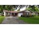 Brick ranch house with attached garage and driveway at 530 Mar Nan Mar Place, Clermont, FL 34711