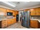 Kitchen with stainless steel appliances and wood cabinets at 734 Boylston St, Leesburg, FL 34748