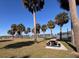 Relaxing park with picnic tables under palm trees near the water at 734 Boylston St, Leesburg, FL 34748