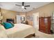 Spacious main bedroom with king-size bed and views of the living area at 9033 Saint Andrews Way, Mount Dora, FL 32757