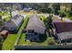 Aerial view of the home featuring a manicured lawn, fenced yard, and patio at 973 Belle Oak Dr, Leesburg, FL 34748