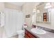 Cozy bathroom featuring a shower-tub combo and single sink vanity with vanity lighting at 973 Belle Oak Dr, Leesburg, FL 34748