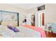 Comfortable bedroom with walk-in closet and ensuite bath featuring elegant dresser with round mirrors at 973 Belle Oak Dr, Leesburg, FL 34748